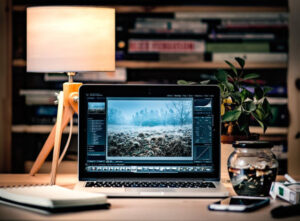 Adobe Photoshop running on a Macbook on a desk