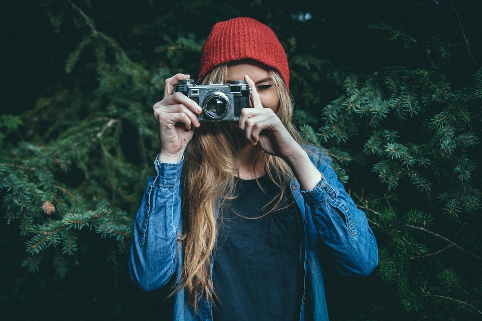 Female photographer using an analog camera